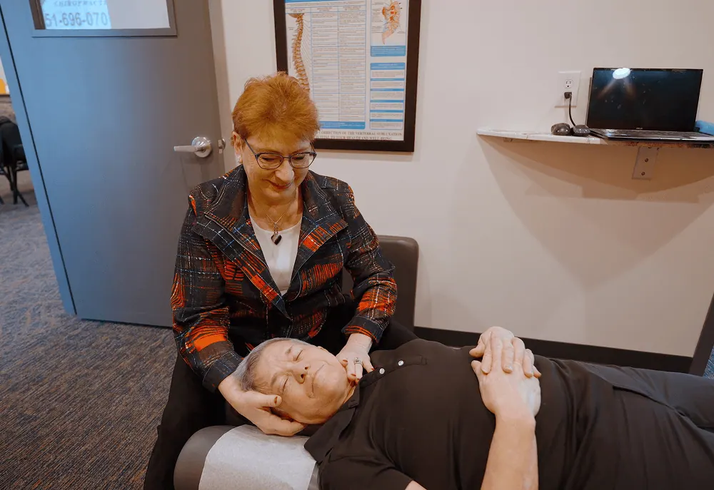 Dr. Trish Wolff treating a patient's head and neck