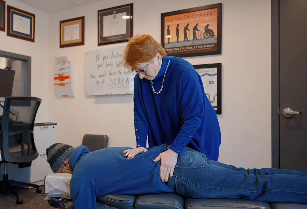 Dr. Trish Wolff performing a spinal adjustment