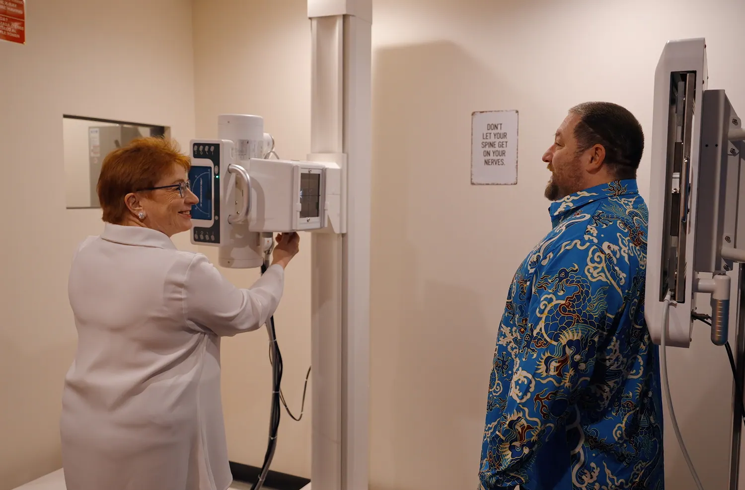 Dr. Trish Wolff positioning a patient for a spinal X-ray