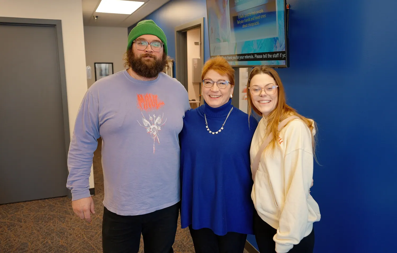 Dr. Trish Wolff standing with two patients in the clinic