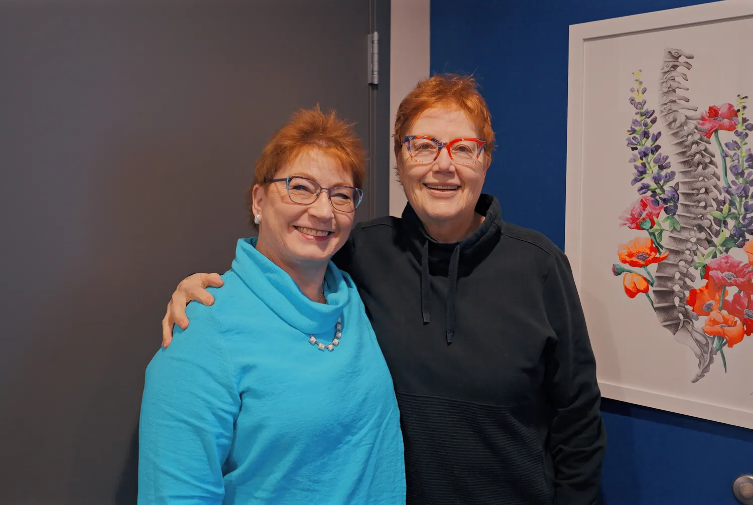 Dr. Trish Wolff with a smiling patient in the hallway