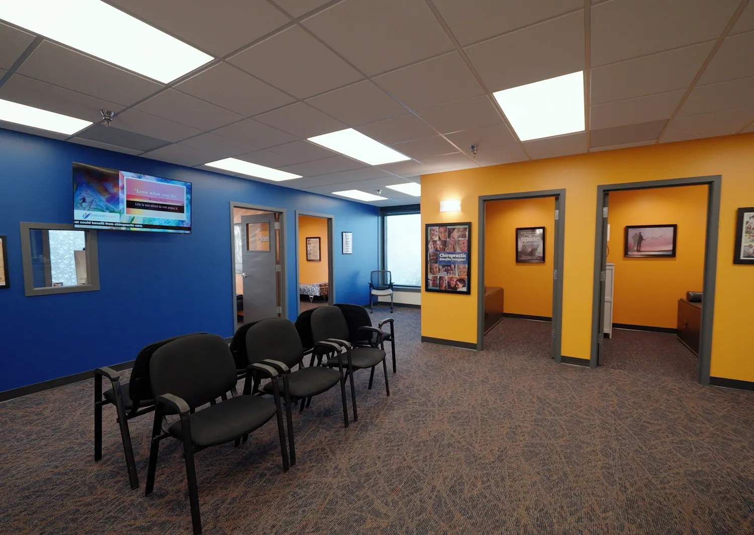 Waiting room with blue and orange walls at Natural Ways Chiropractic